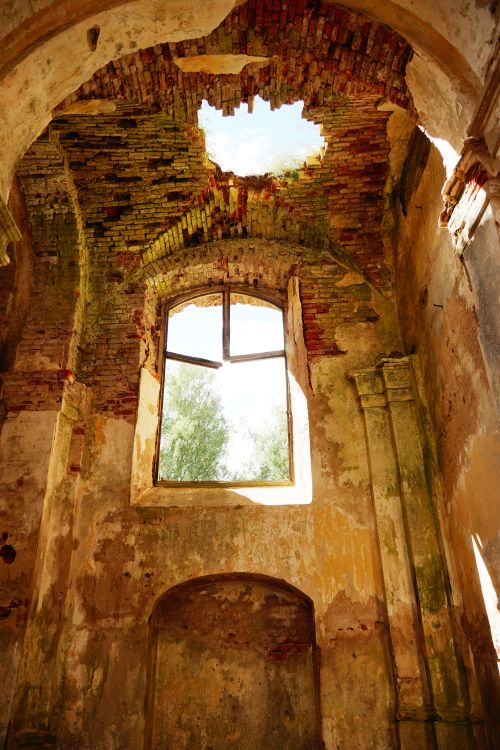 Free Interior of an old abandoned building with a collapsed roof letting sunlight in. Stock Photo