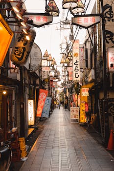 Vibrant Tokyo street lined with neon signs and lanterns, capturing urban life and culture.