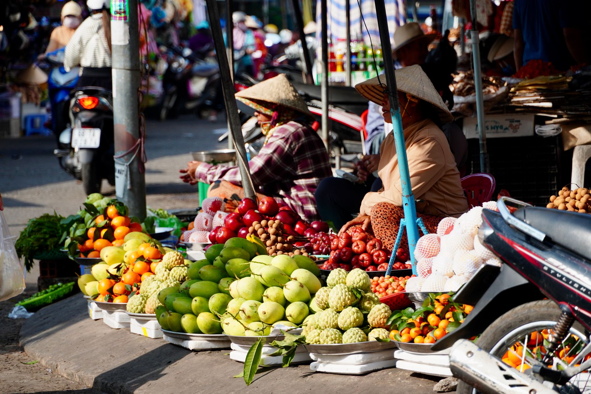 Colorful display of tropical fruits at an open-air market, showcasing daily life.