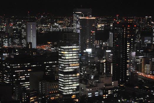 A stunning cityscape showcasing vibrant lights and skyscrapers under the night sky.