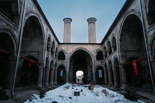Capture of the iconic Double Minaret Madrasa in Turkey during winter, showcasing its historic architecture.