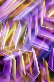 Colorful abstract motion blur featuring purple and gold tones.