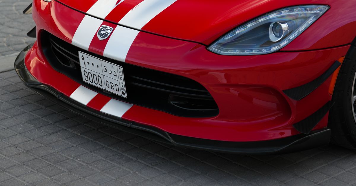 Canadian Racing Red Colour Red Sports Car with Racing Stripes Parked Outdoors · Free Stock Photo