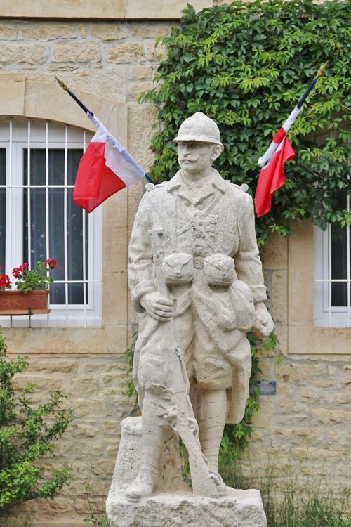 Free Stone statue of a soldier with French flags in Gabriac, Occitanie, France, symbolizing national pride. Stock Photo