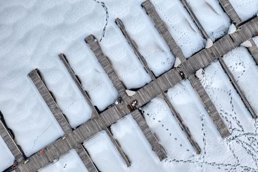 Aerial shot of a snow-covered pier with wooden docks in Pepin, Wisconsin.