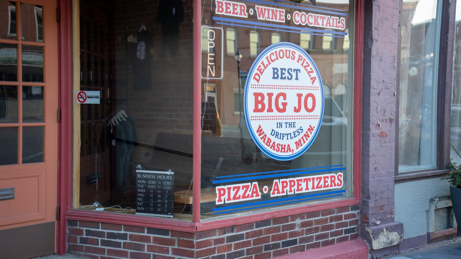 Charming storefront of Big Jo's Pizza in Wabasha, MN, displaying beer, wine, and appetizers.