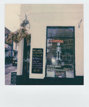 Vintage-style polaroid photo of a cozy coffee shop exterior with unique decor.