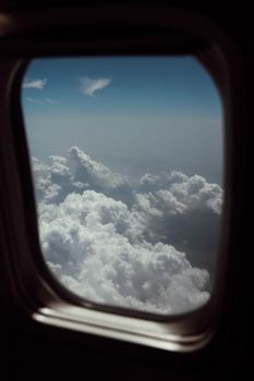 Scenic view of fluffy clouds through airplane window over Norway.