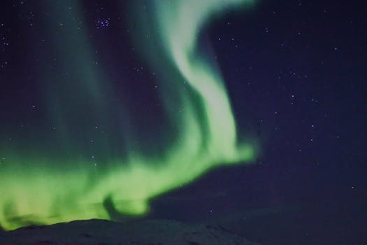Capture of the mesmerizing green aurora borealis dancing over Tromsø, Norway.