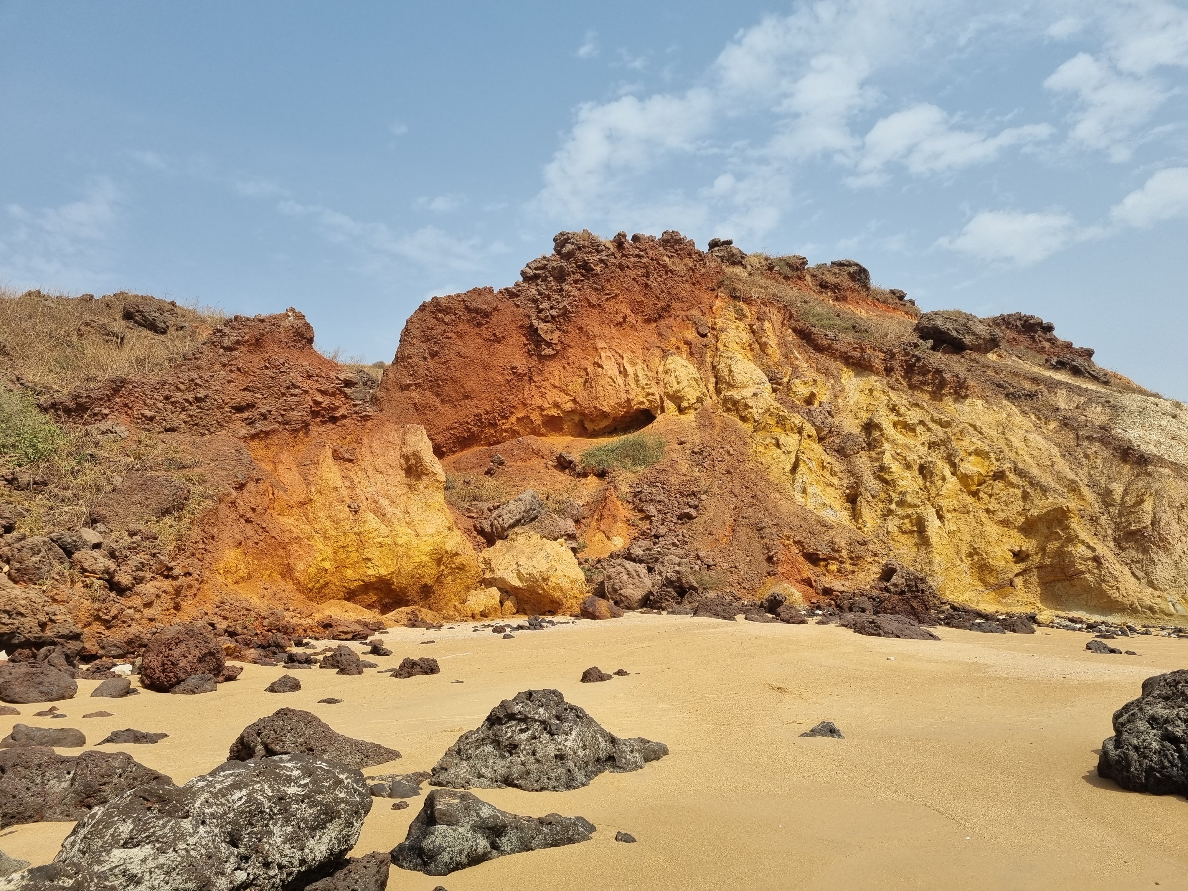 Dramatic Coastal Cliff with Colorful Layers · Free Stock Photo