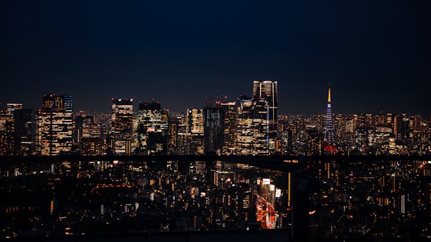 Night view of Tokyo's illuminated skyline featuring iconic towers and modern skyscrapers.