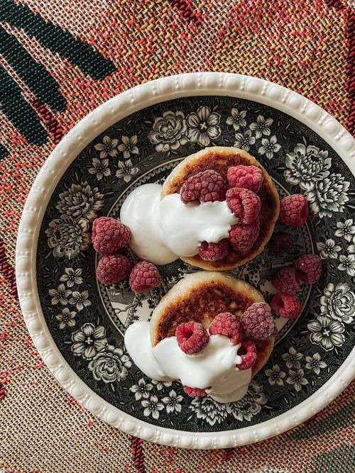 Free Top view of raspberry pancakes with cream on a decorative plate. Stock Photo