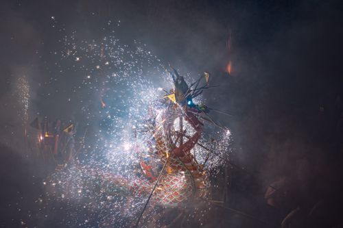 Free A dynamic display of fireworks erupting from a dragon figure, captivating the crowd during a vibrant night festival. Stock Photo