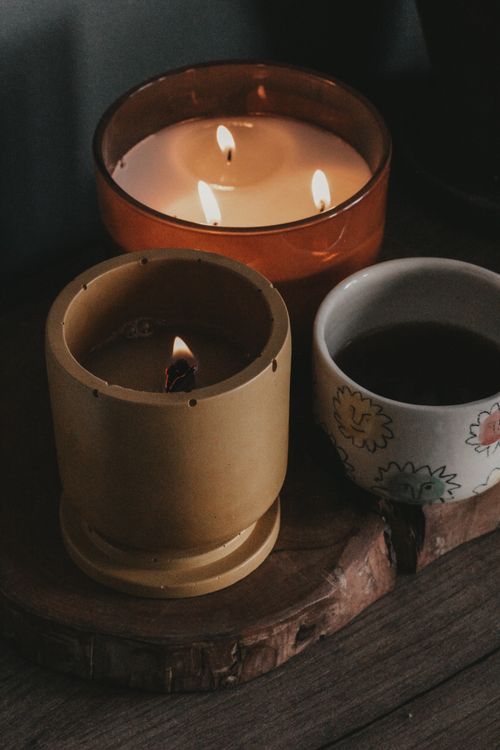 Free Warm candlelit setting with coffee cup, perfect for cozy ambiance and relaxation themes. Stock Photo