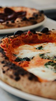 A mouthwatering view of a Margherita pizza with fresh ingredients and melted cheese.