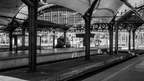 Free Black and white image of a historic train station with vintage architecture. Stock Photo