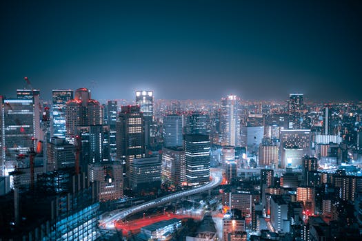 Stunning aerial view of Osaka's city lights and skyscrapers at night.