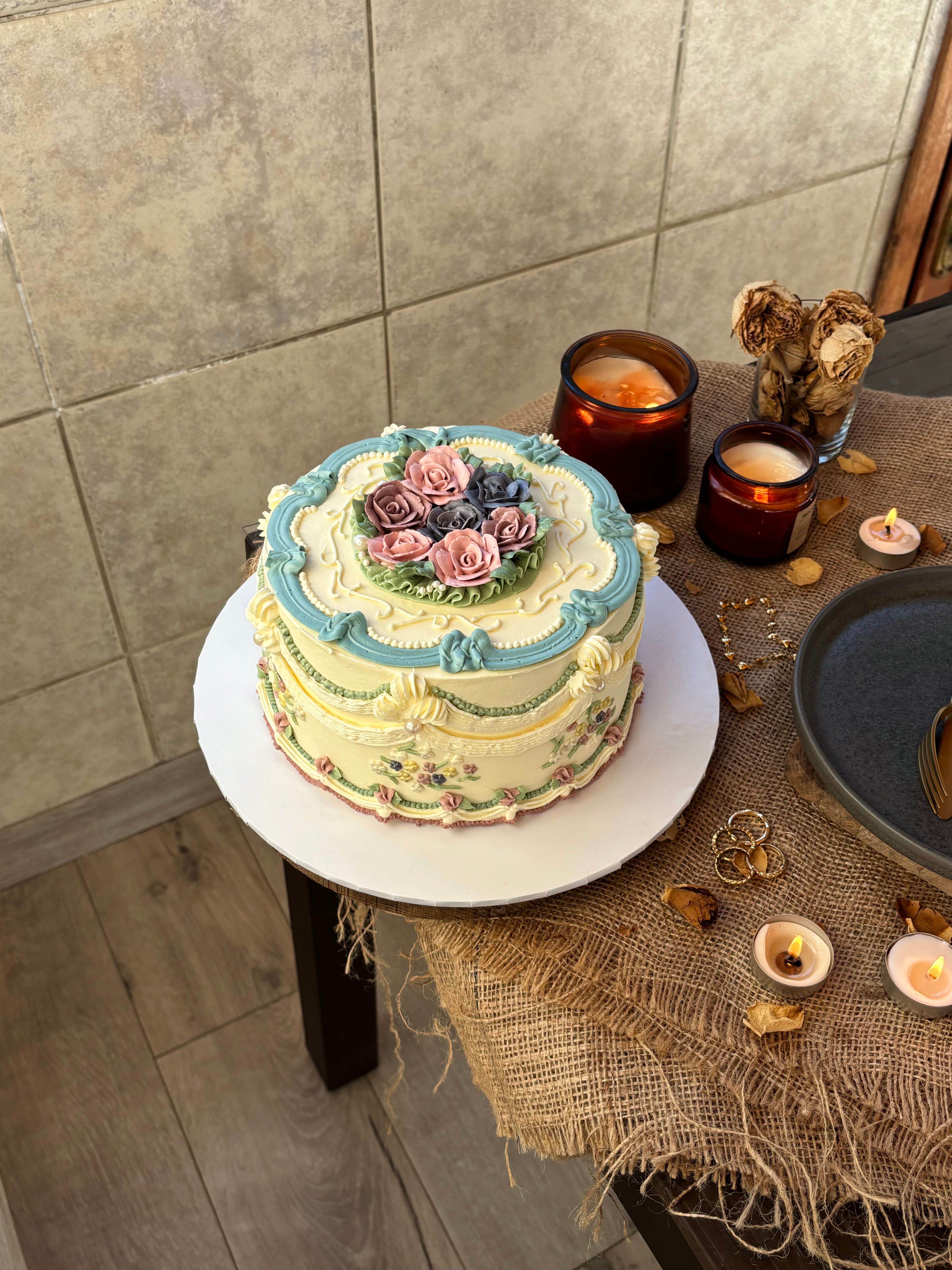 Vintage Decorated Cake with Floral Design and Candles · Free Stock Photo