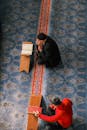 Two Individuals Reading in a Mosque Interior