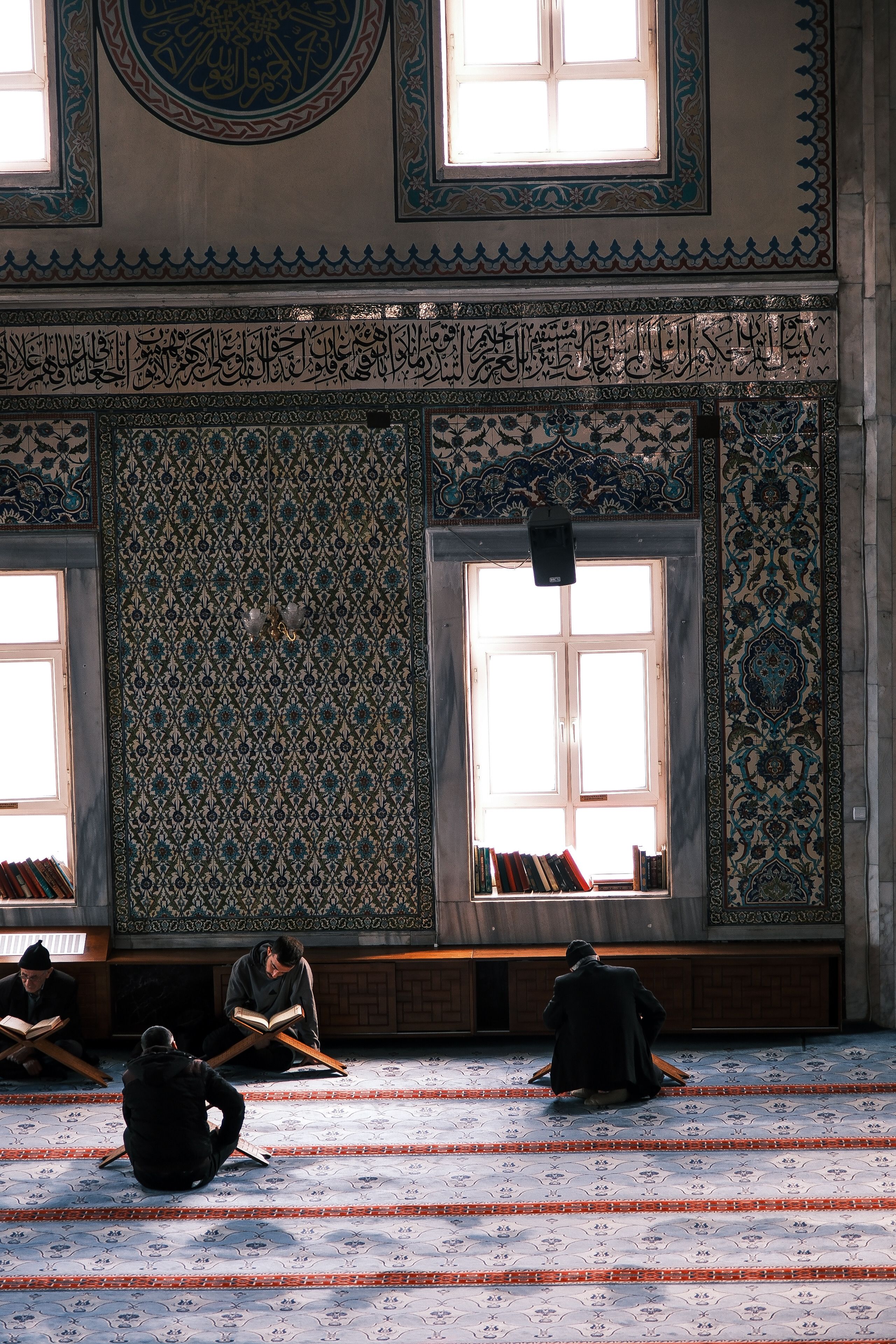 People Reading Inside an Ornate Mosque Interior · Free Stock Photo