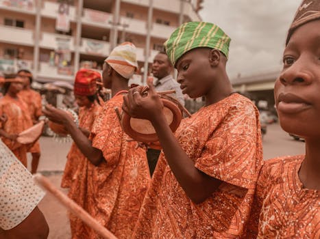 Colorful street festival featuring African drummers in traditional attire performing outdoors.