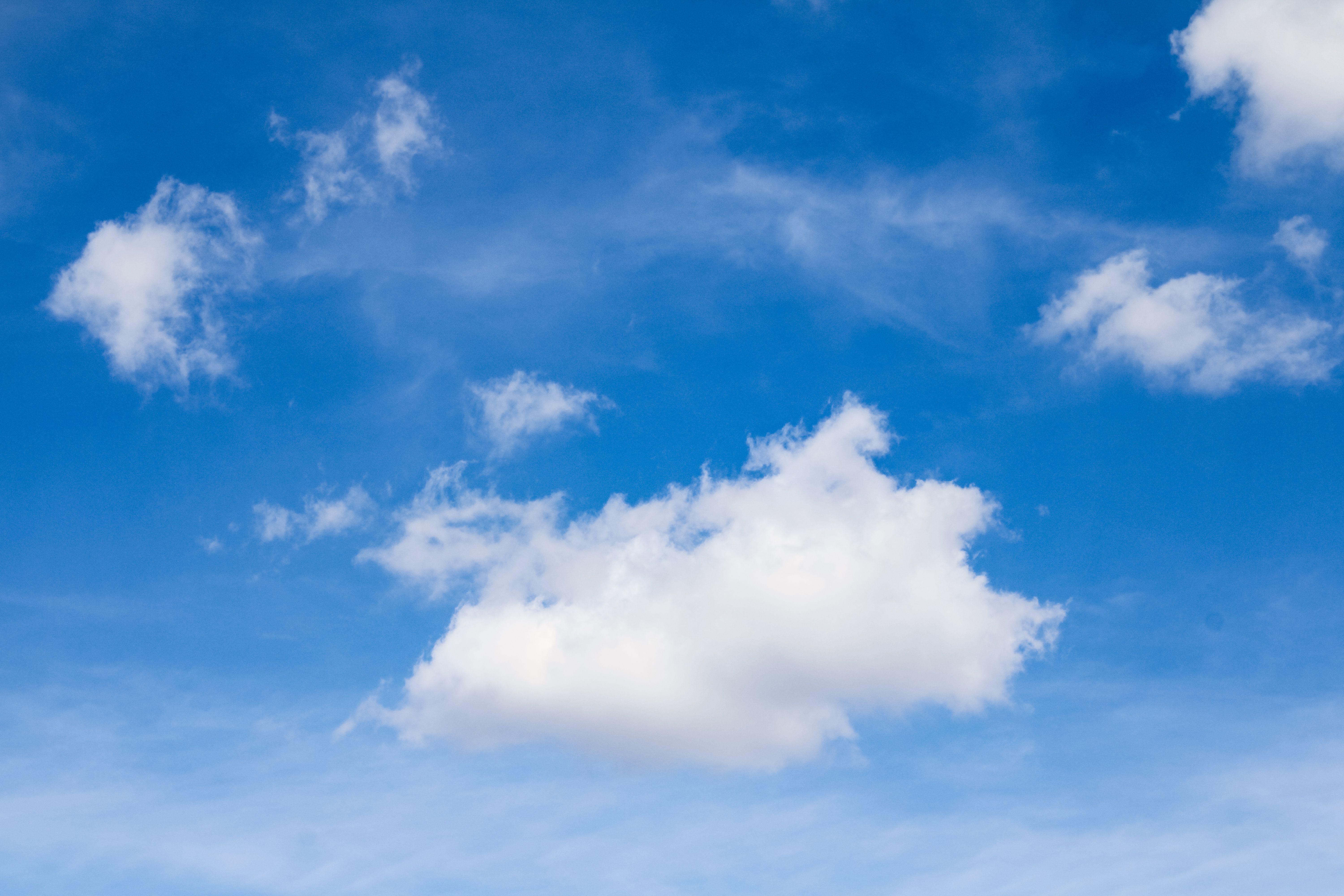 Bright Blue Sky with Fluffy White Clouds · Free Stock Photo