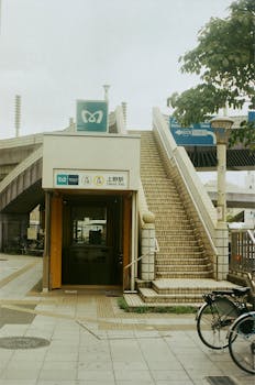 Vintage look of Ueno Station entrance in Tokyo with outdoor stairway and bicycle.