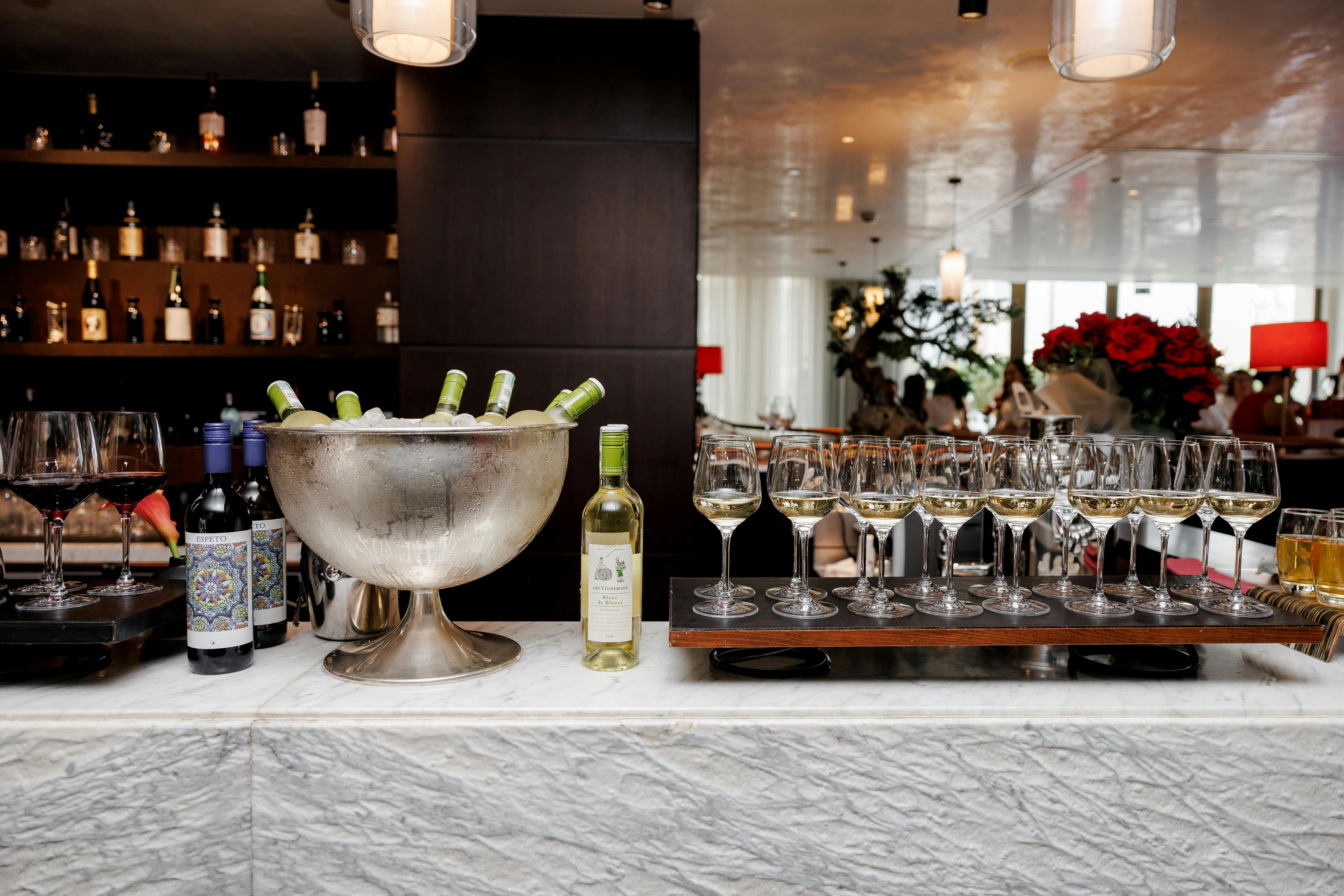 Sophisticated bar setup with wines and glasses in a luxury restaurant setting in Astana, Kazakhstan.