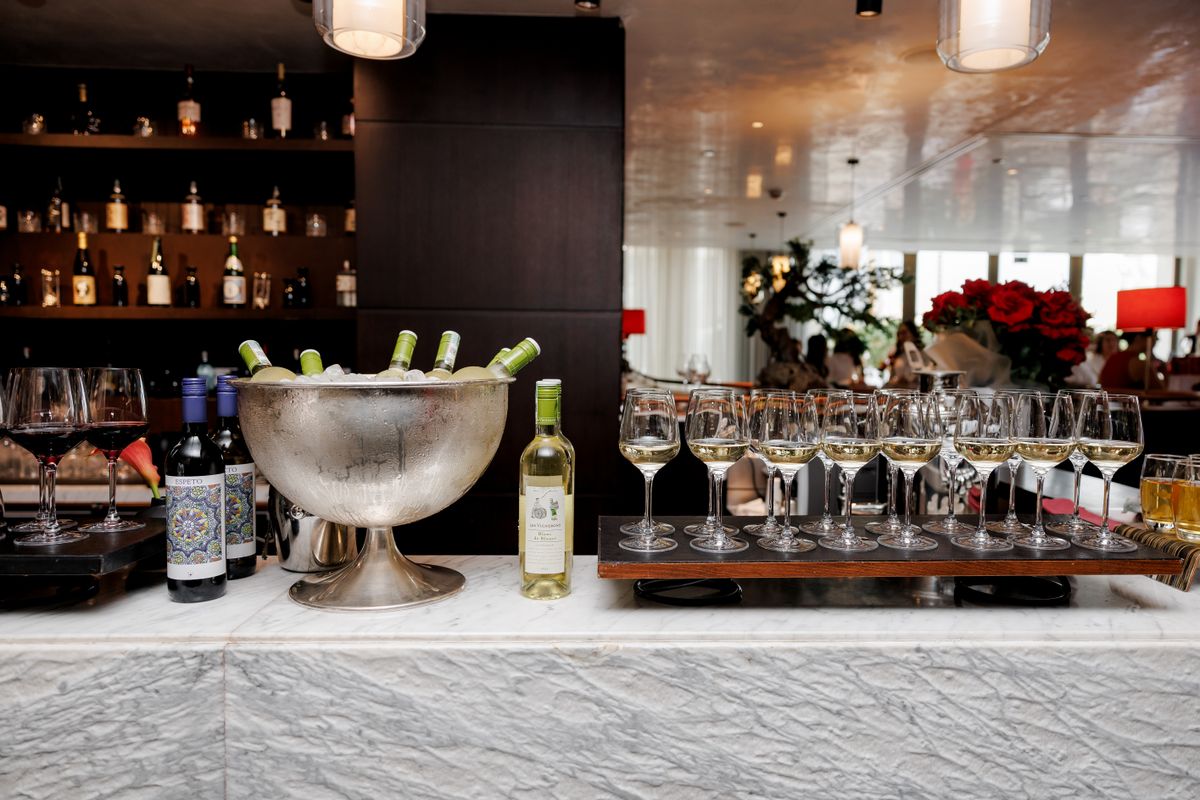 Wine bar with glass dispensers and bottles