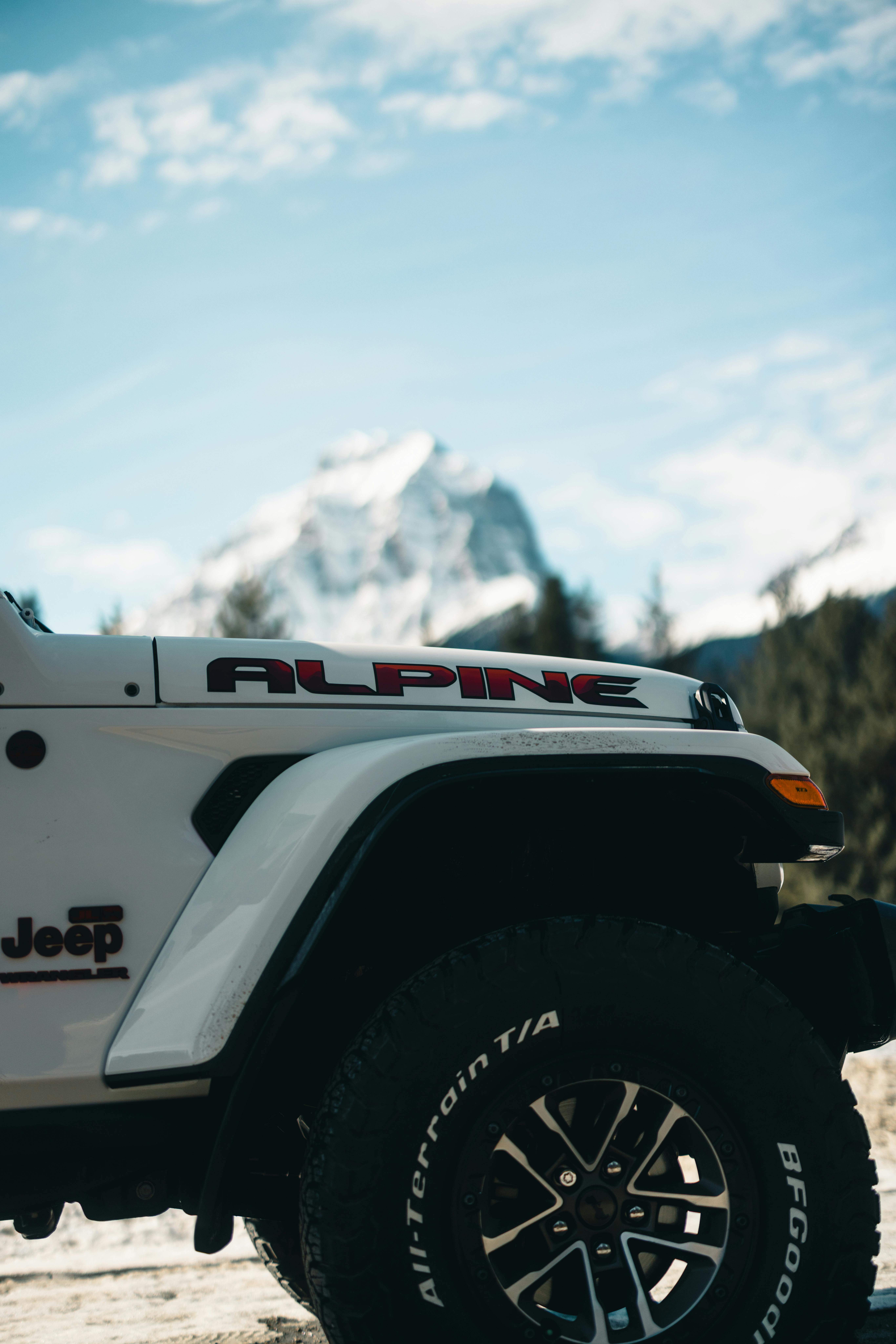 Jeep Wrangler in Jasper National Park with mountain backdrop.