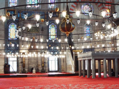 Free Interior of a historic mosque featuring beautiful stained glass and ornate chandeliers, offering a tranquil atmosphere. Stock Photo