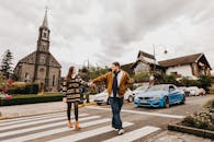 一对幸福的夫妇手牵着手，在教堂前过马路