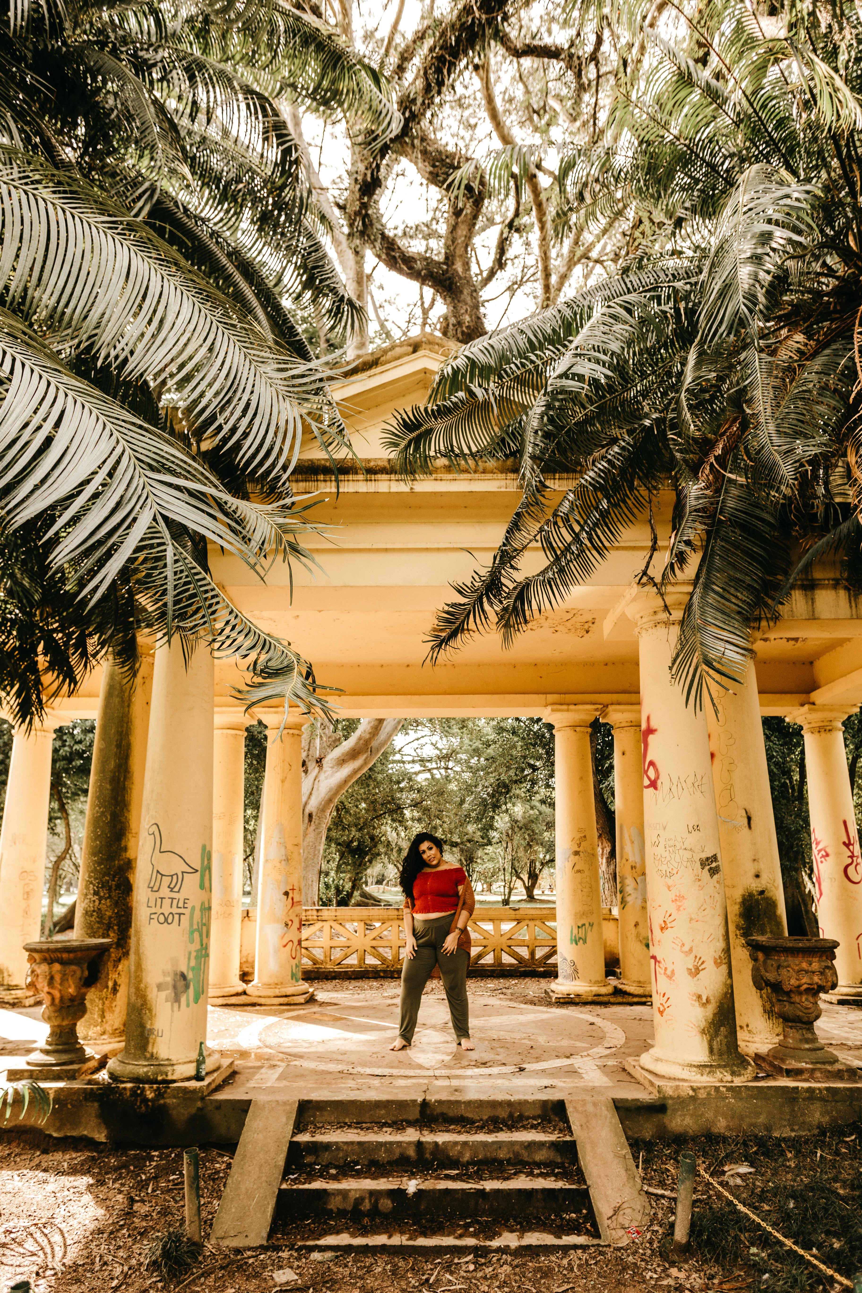 woman standing inside beige concrete structure