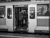 Person Boarding a Train in Black and White