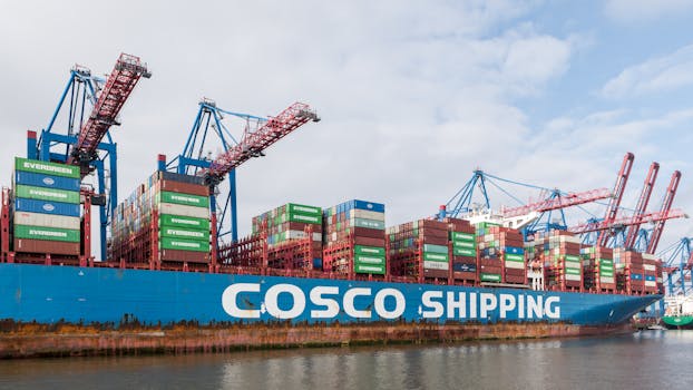 A large container ship docked at Hamburg Port, showcasing global trade and shipping containers.