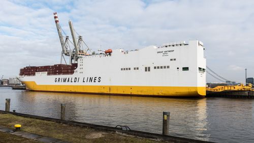 Free Container ship docked at Hamburg Port, showcasing global trade and shipping industry. Stock Photo