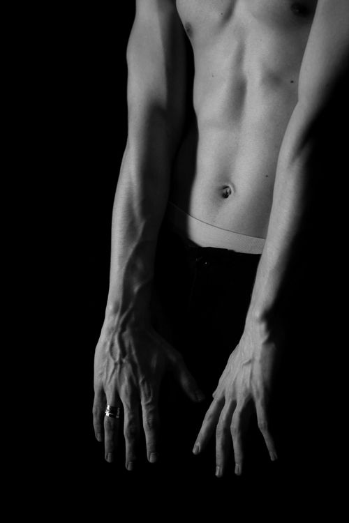 Free Black and white photo of a male torso with dramatic lighting and shadow play. Stock Photo