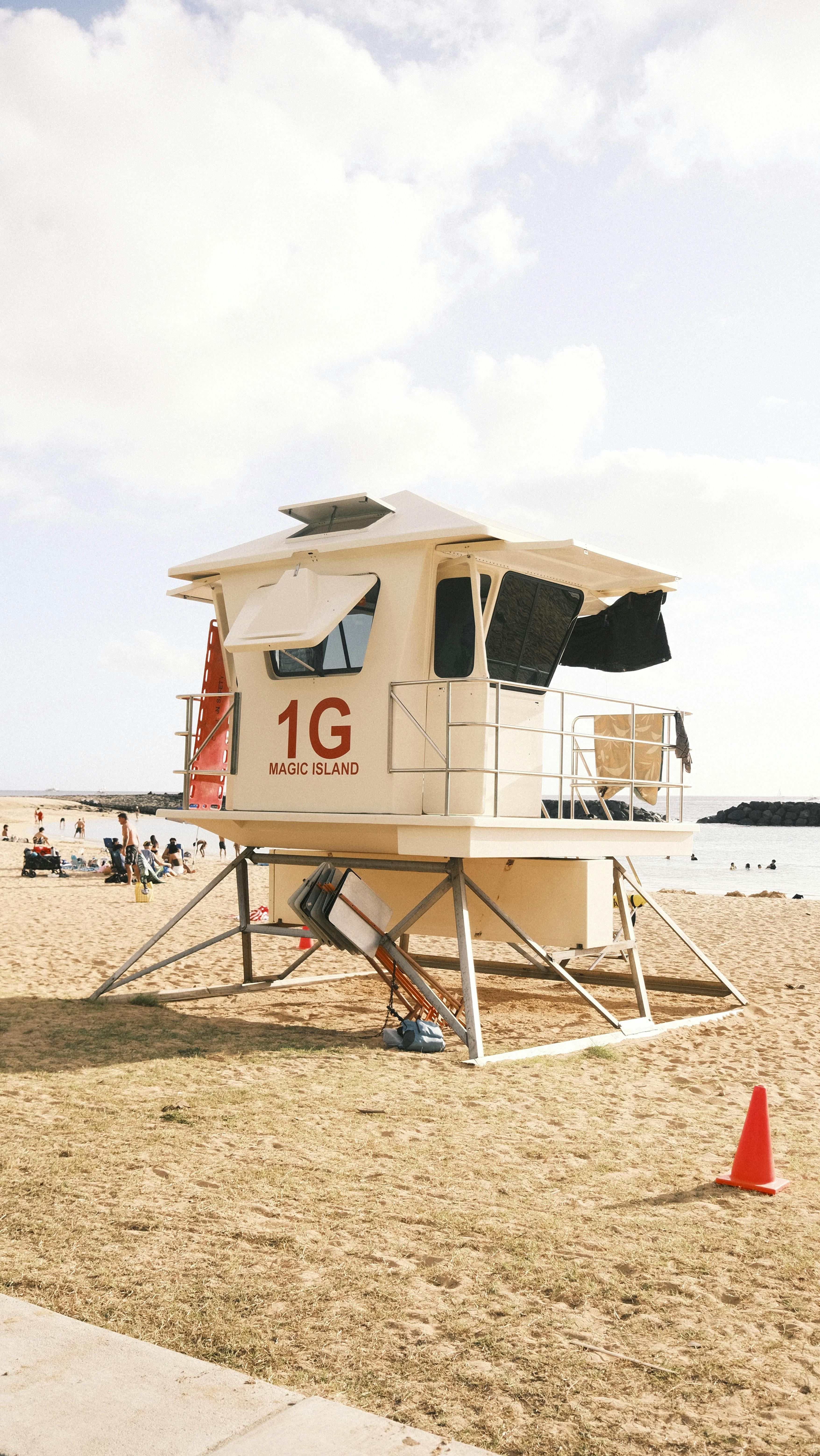 Lifeguard tower on a sunny beach at Magic Island, perfect for a summer getaway.