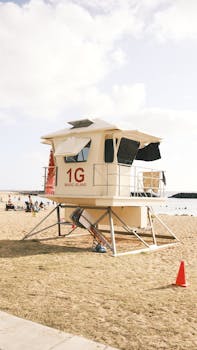 Lifeguard tower on a sunny beach at Magic Island, perfect for a summer getaway.