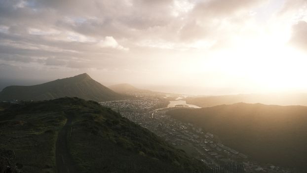 A breathtaking view of mountains and cityscape at sunrise, capturing natural beauty.