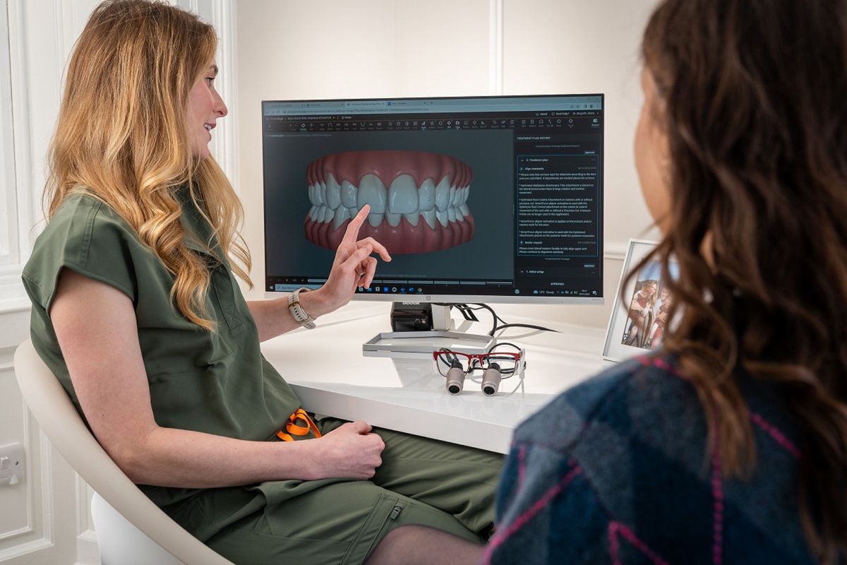 Dentist explaining a treatment plan to a patient using an X-ray
