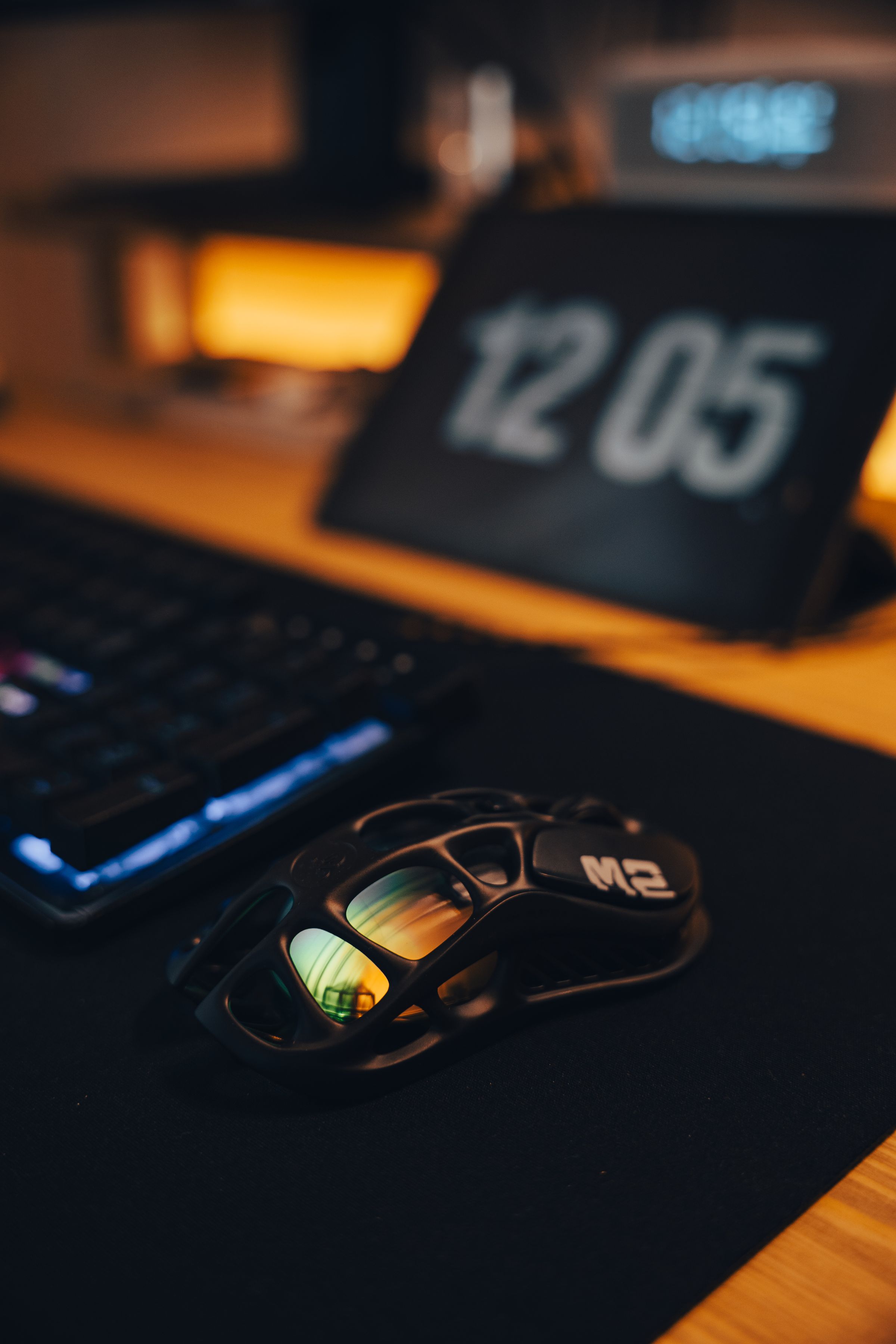 Modern gaming desk with keyboard mouse and restrained ambient lighting