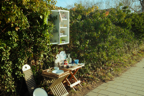 Free Charming vintage outdoor tea setup against lush ivy wall, sunny day. Stock Photo