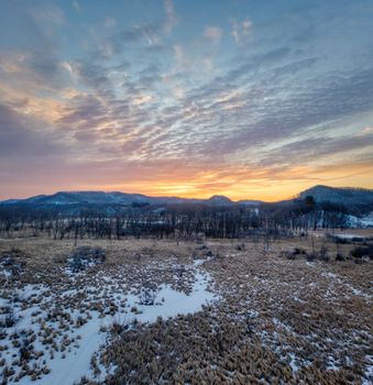 A breathtaking sunrise over snowy fields and distant hills in Tell, Wisconsin.