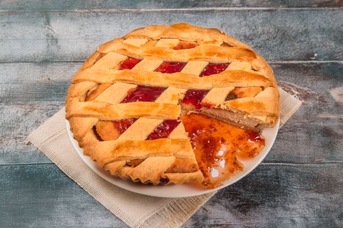 Free Freshly baked strawberry tart with lattice crust on a wooden table in Lima, Perú. Stock Photo