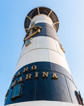 A striking view of Faro Marina Lighthouse under a clear sky in Miraflores, Peru.