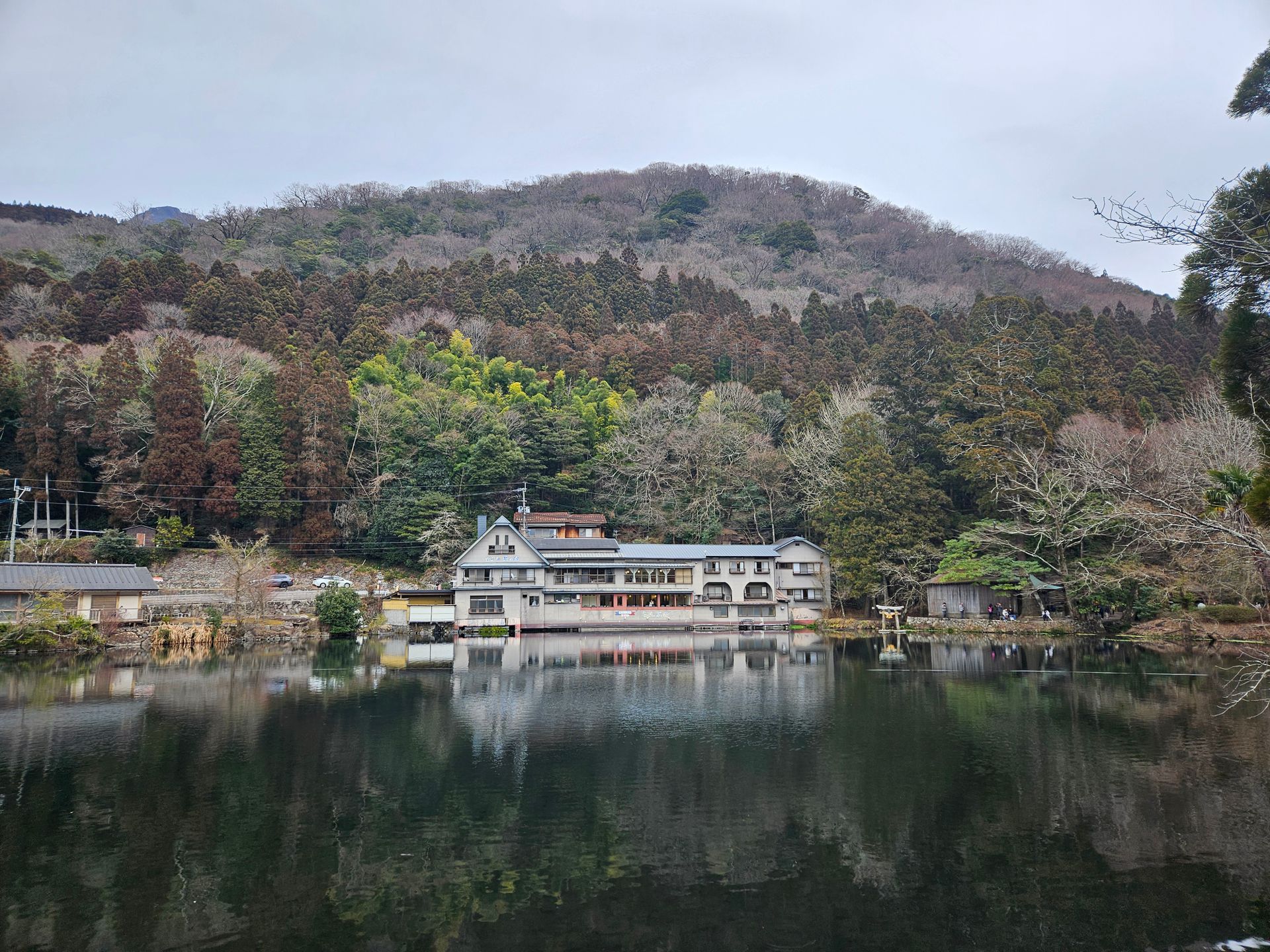 Serene view of a Japanese village by the lake in Fukuoka during early spring.