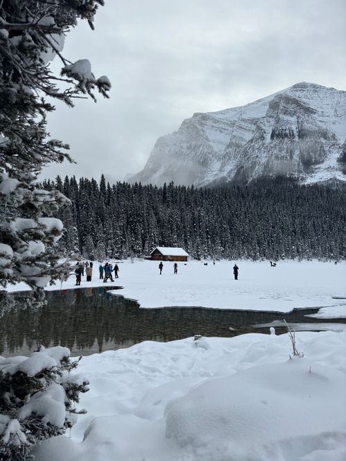 Free Winter landscape with Lake Louise, frozen lake, and snow-covered mountains in Banff National Park, Canada. Stock Photo