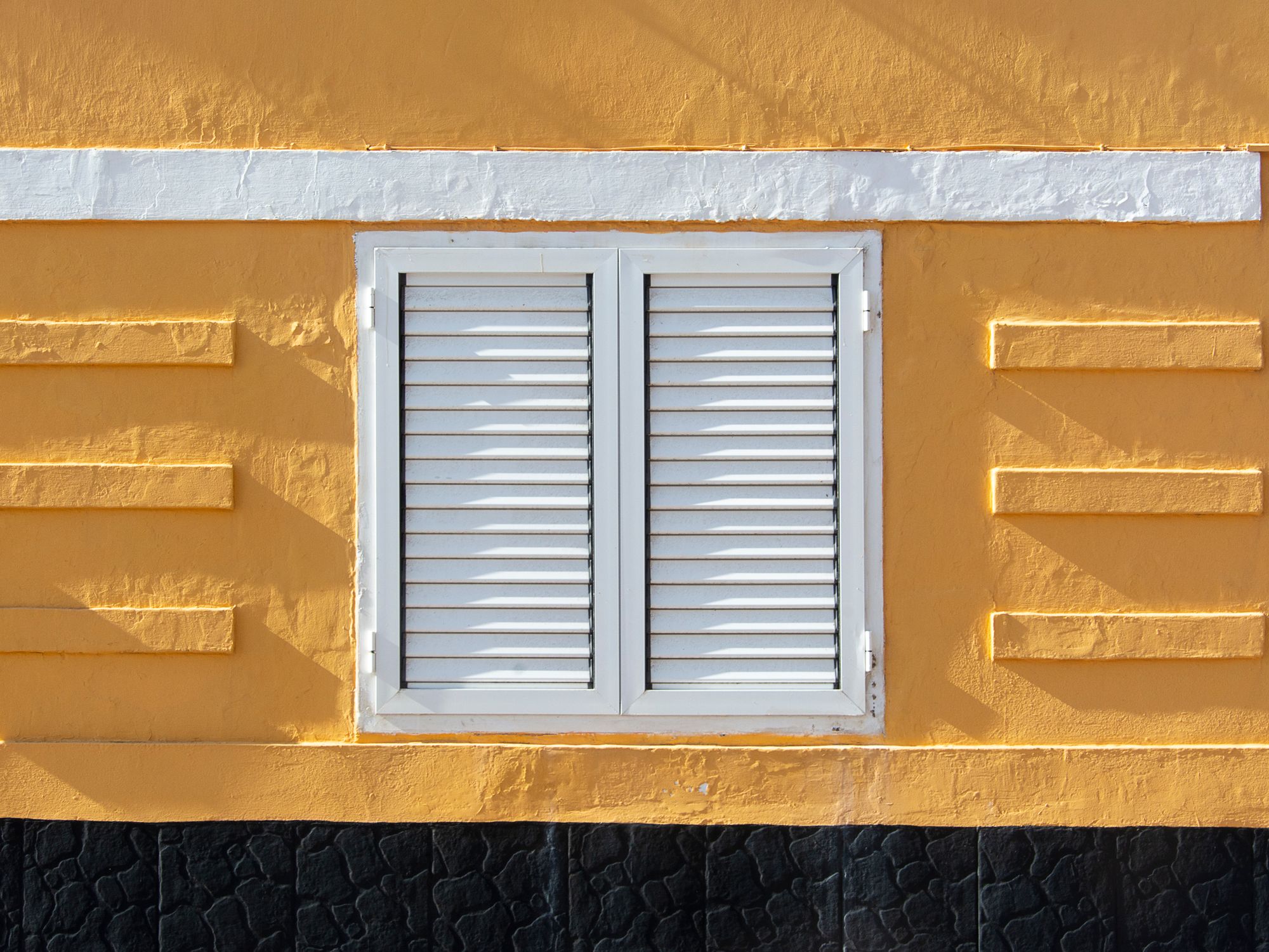 Painters & Decorators in Wanstead, London — professional decorator painting a wall with a roller