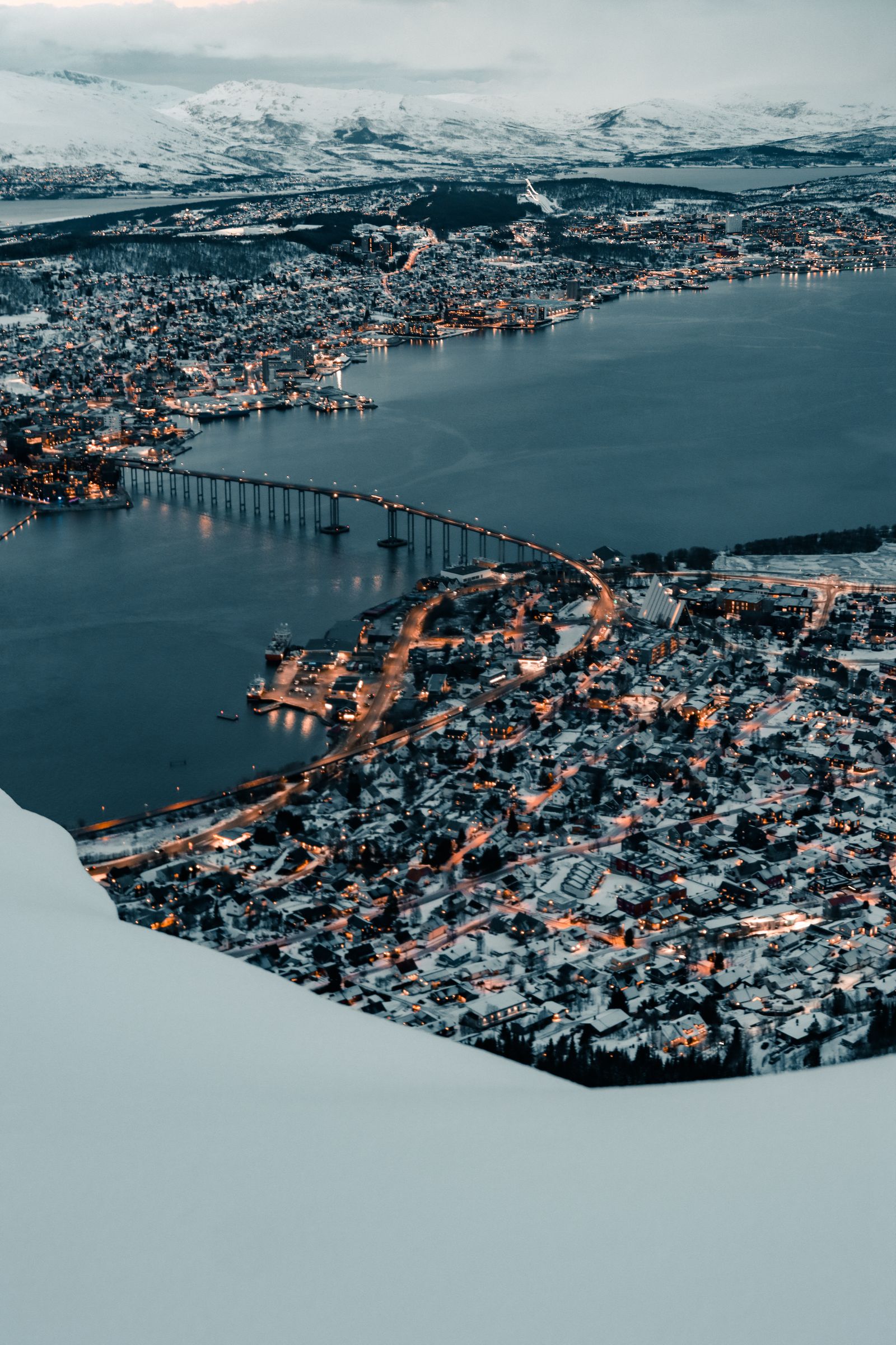 Tromsø aerial view in winter with fjord and snowy mountains